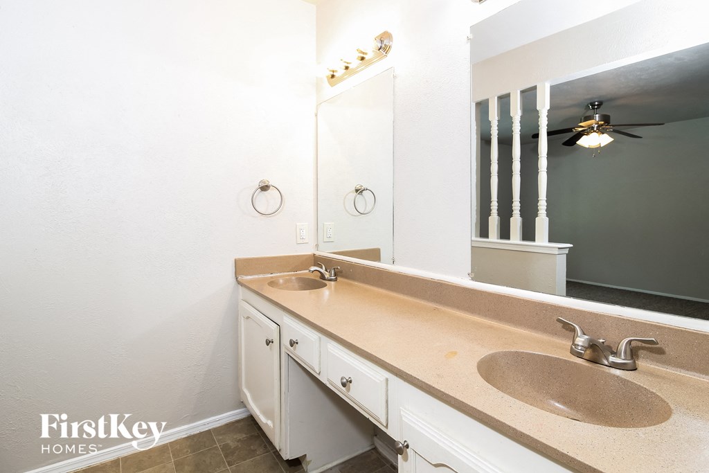 a bathroom with two sinks and a large mirror