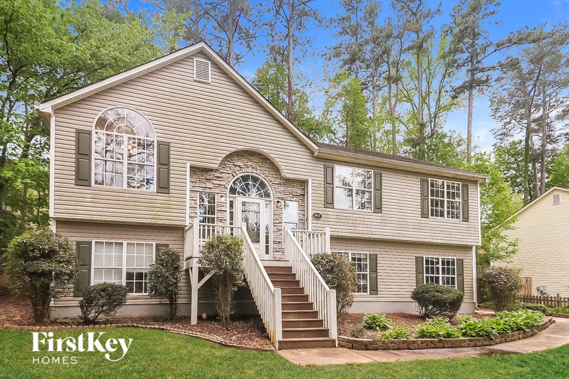 the exterior of a house with a staircase and a yard