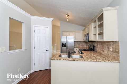 a kitchen with a counter top and a refrigerator