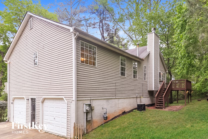 a white house with a white garage and a staircase