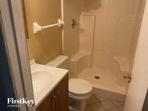 a small bathroom with a sink toilet and shower