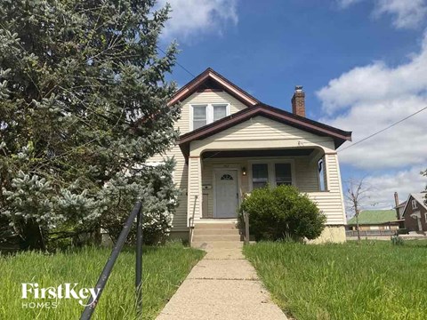 an old house with a sidewalk in front of it