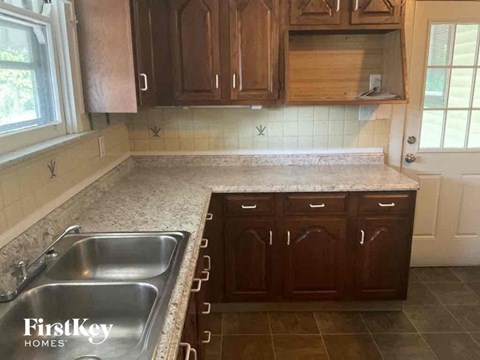 a kitchen with a sink and wooden cabinets