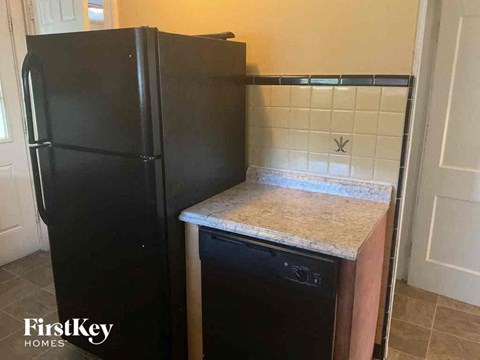a black refrigerator in a kitchen with a counter top