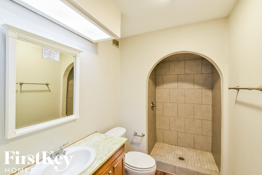 a small bathroom with a shower toilet and sink