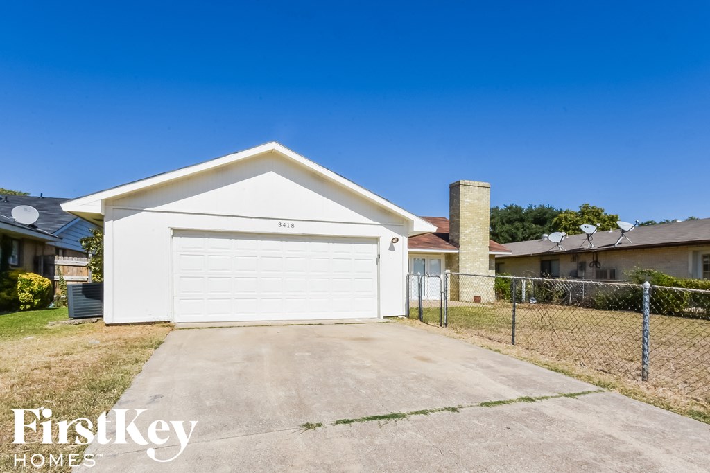 a white house with a driveway and a white garage door