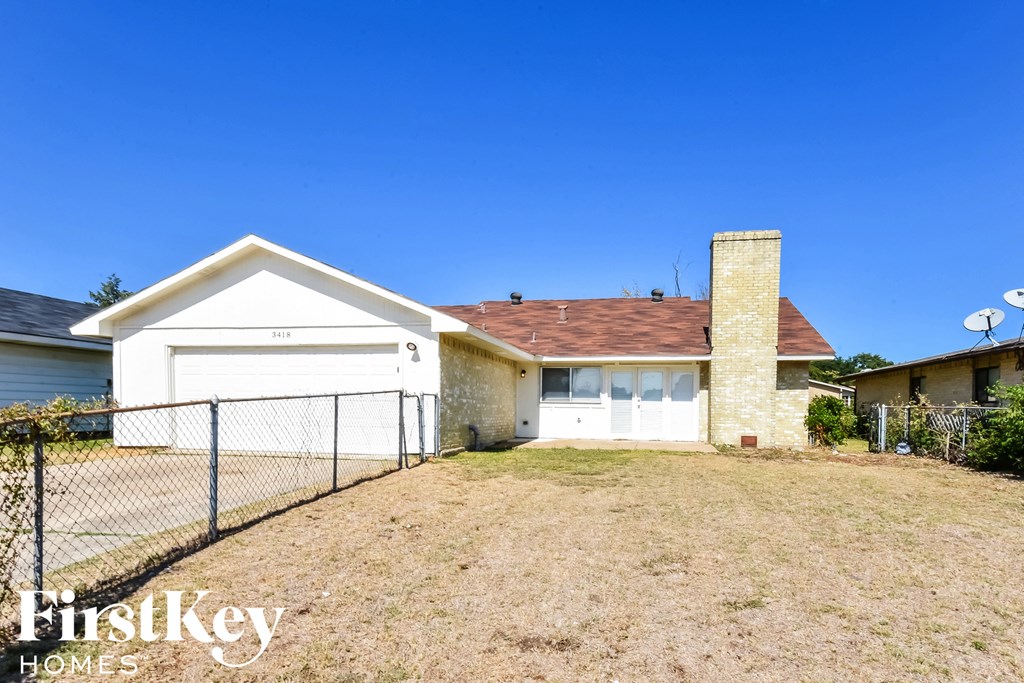a house with a yard and a fence