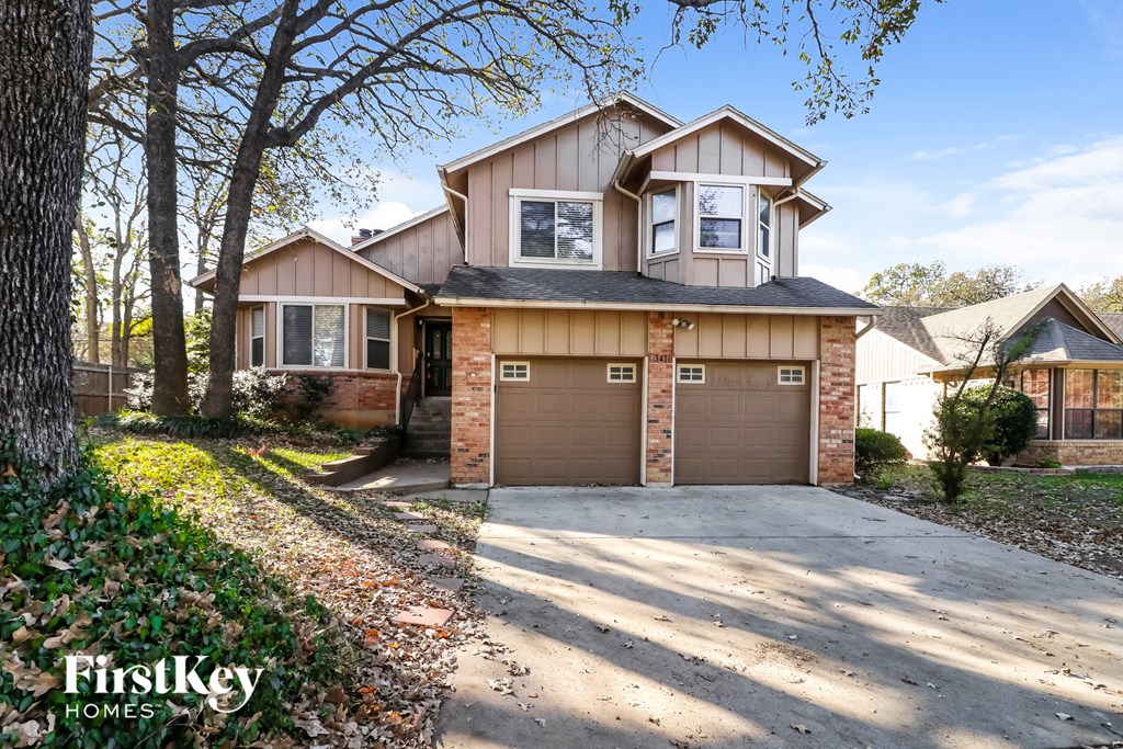 the front of a house with a garage and a driveway