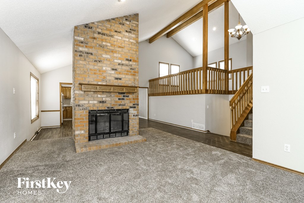 a living room with a fireplace and a staircase