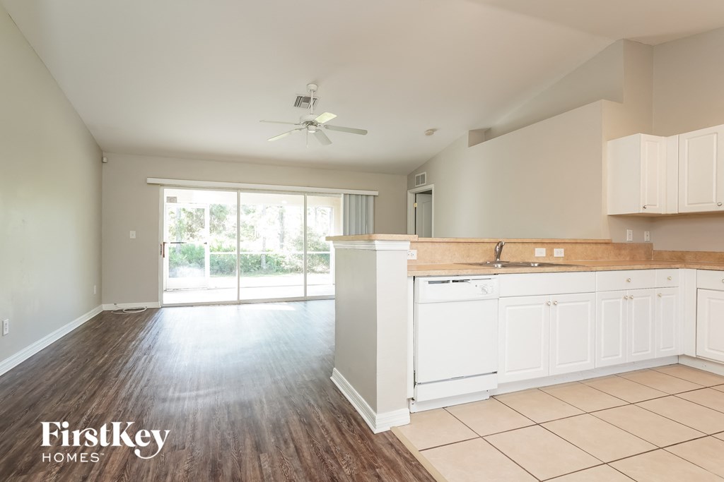 a kitchen with white cabinets and a white counter top