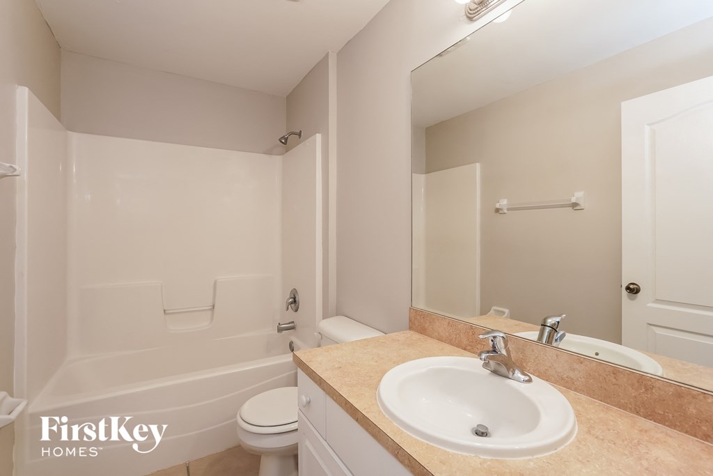 a bathroom with a sink and a toilet and a bath tub