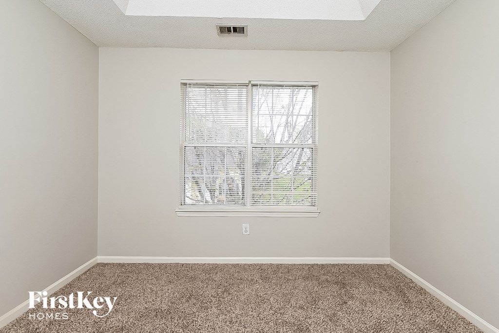 a room with carpet and a window
