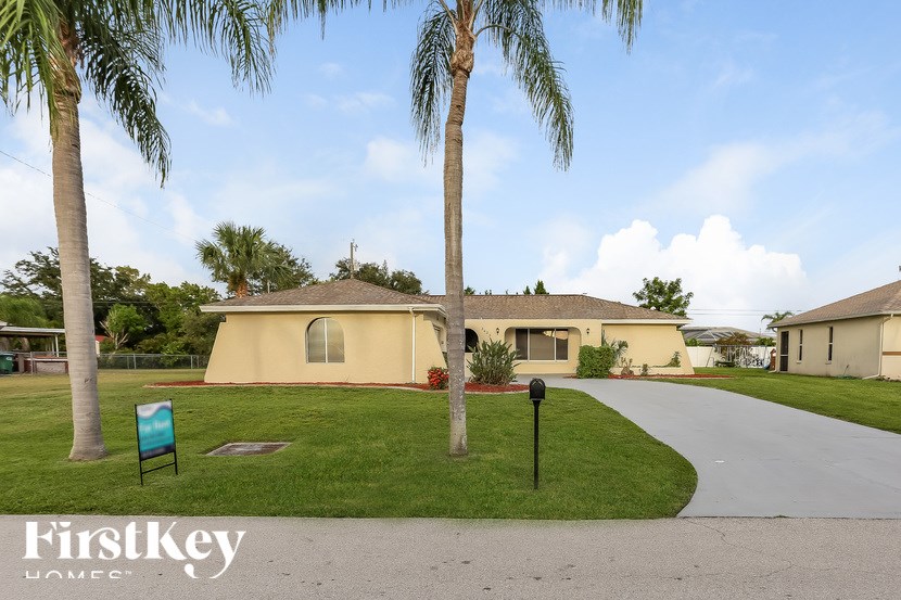 A palm tree stands in front of a house with a sign that says FirstKey Homes.