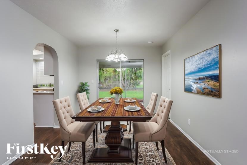 A dining room with a wooden table and chairs.