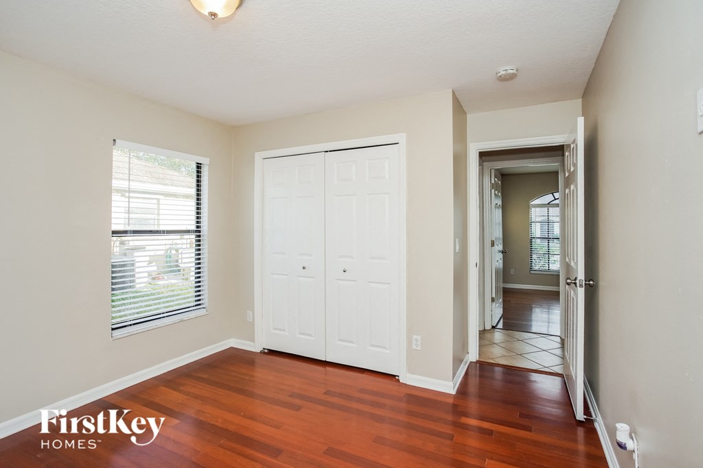a living room with wood floors and a white door