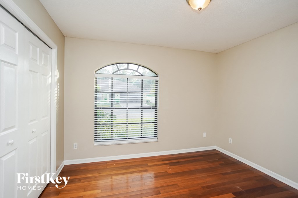 a living room with wood floors and a large window