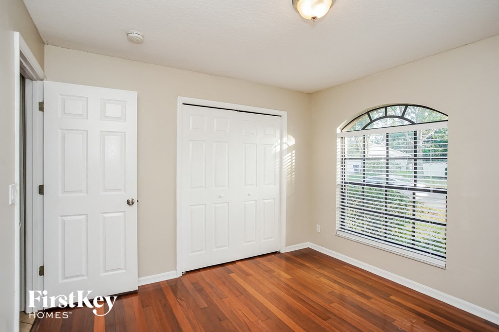 the living room of an empty house with a window and a door