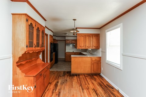 A kitchen with wooden cabinets and a window.