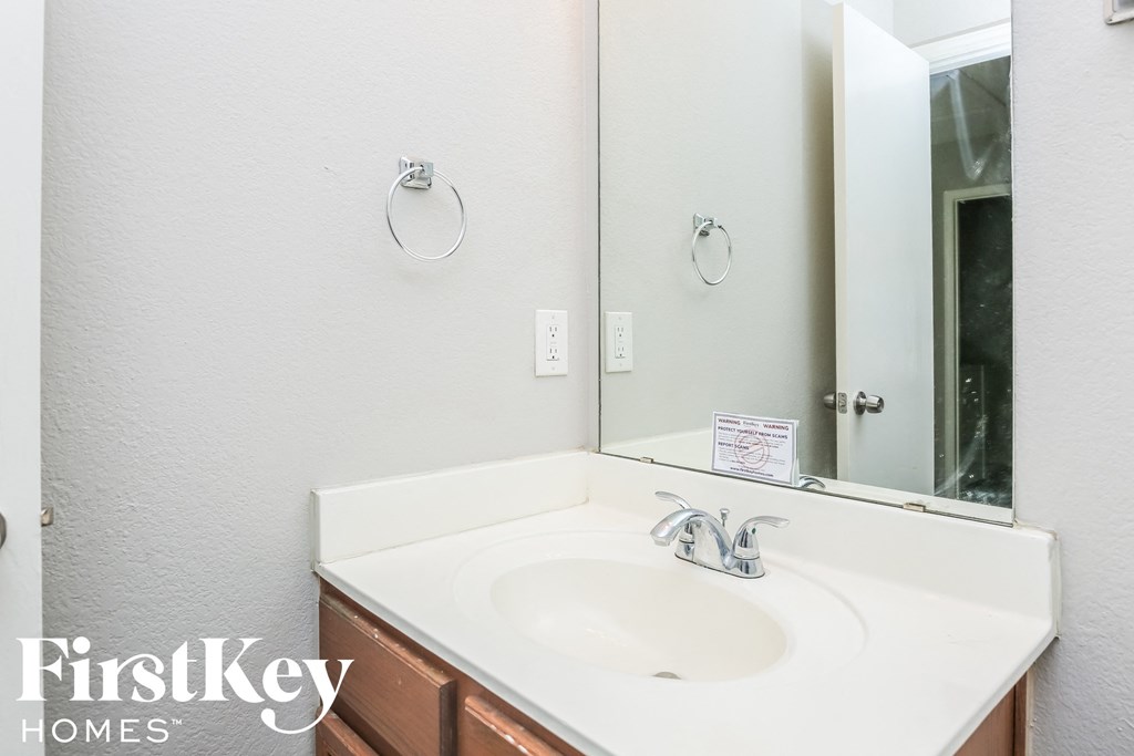a bathroom with a white sink and a mirror