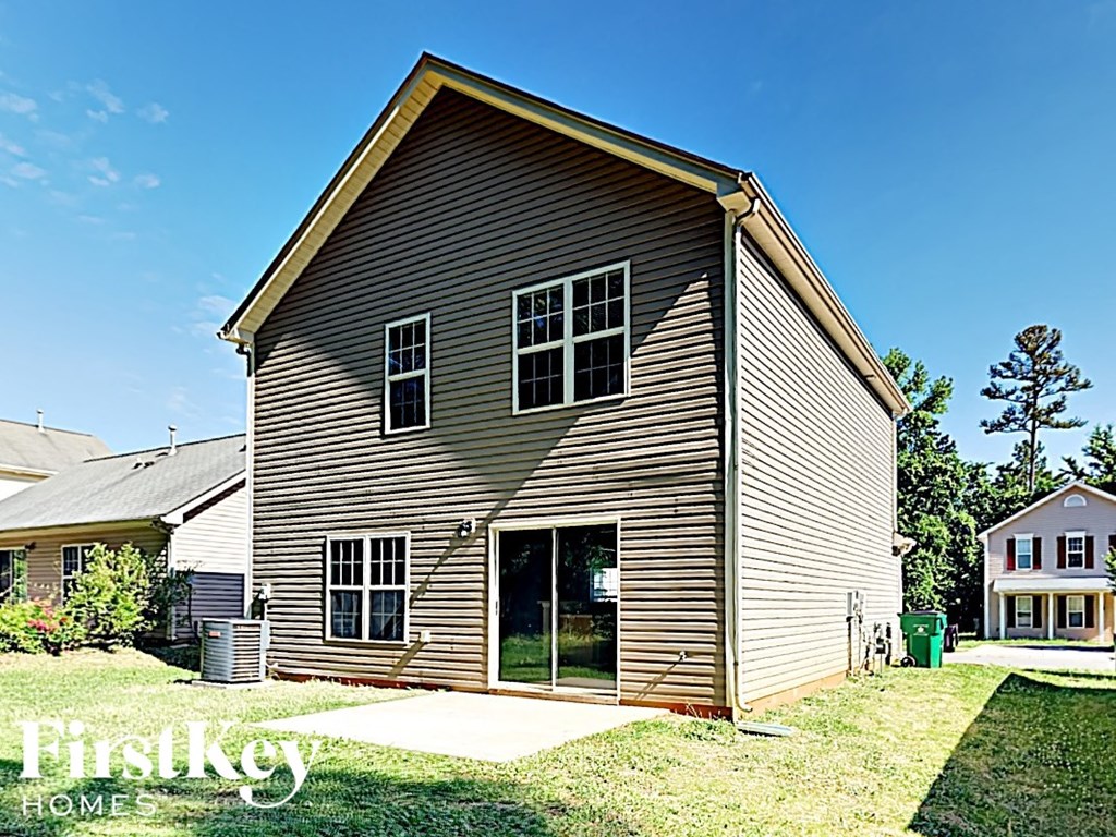 a renovated barn with a garage and a yard