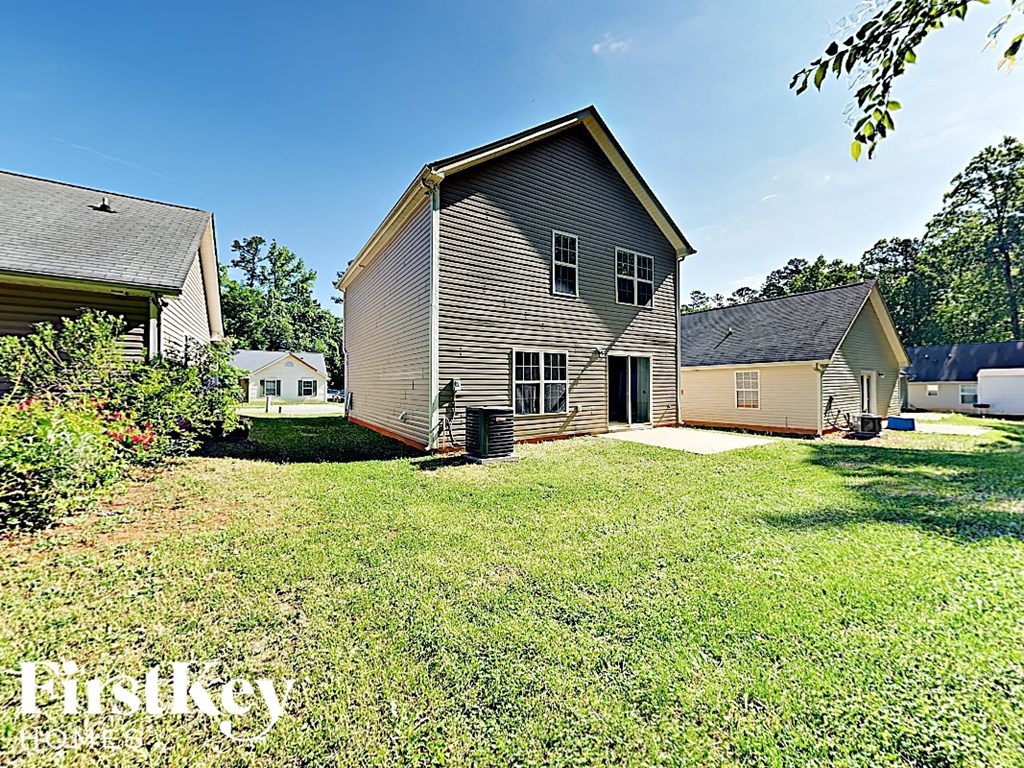 a backyard with a house and a yard