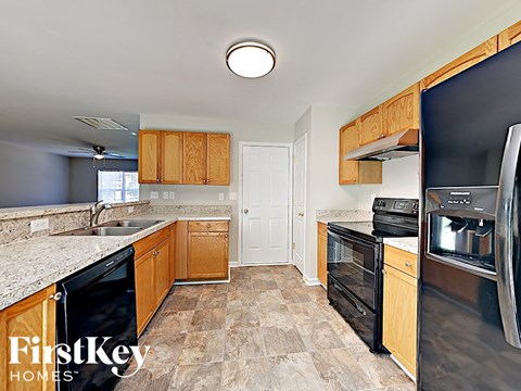 a kitchen with black appliances and wood cabinets