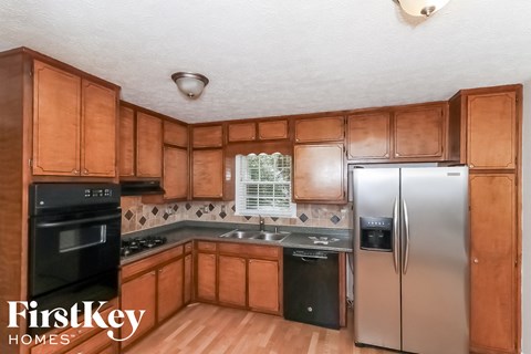 a kitchen with wooden cabinets and stainless steel appliances