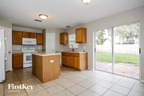 A kitchen with wooden cabinets and a white fridge.