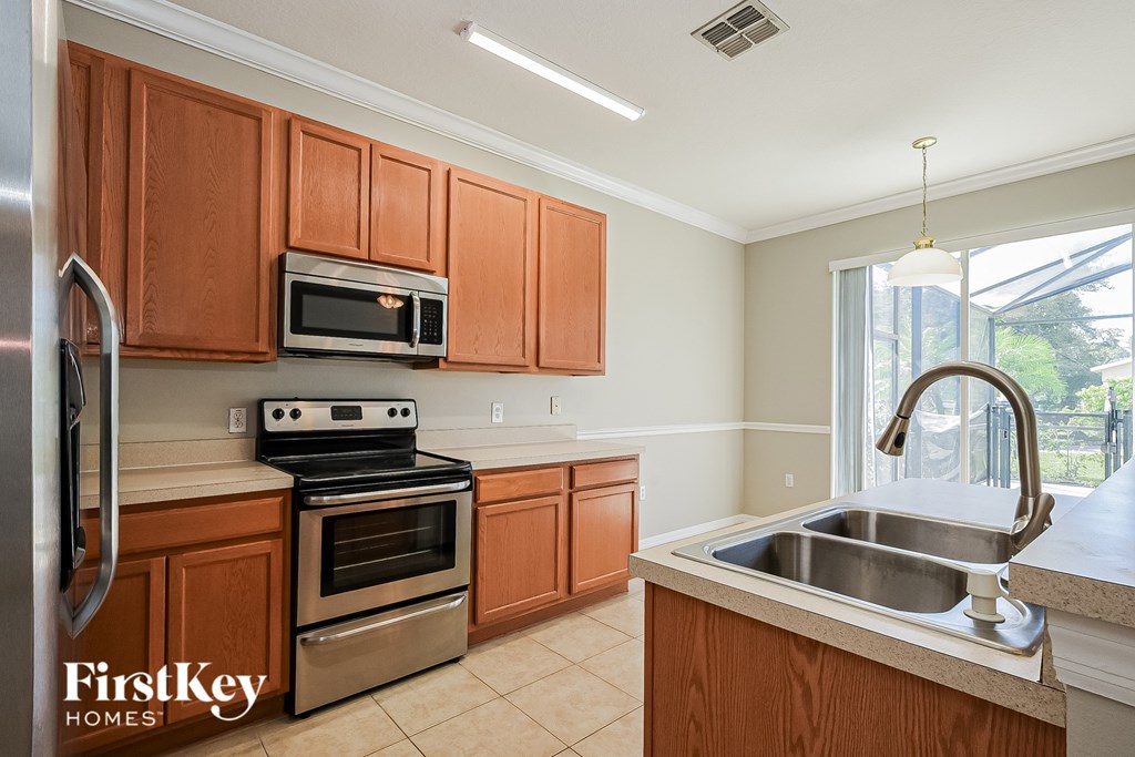 A kitchen with wooden cabinets and stainless steel appliances.