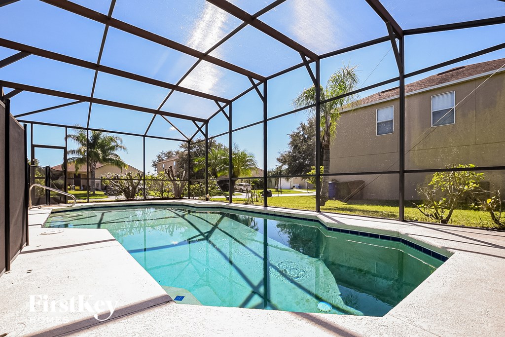 A pool enclosed by a black metal fence.