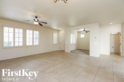 the living room and dining room are spacious and lighted by ceiling fans