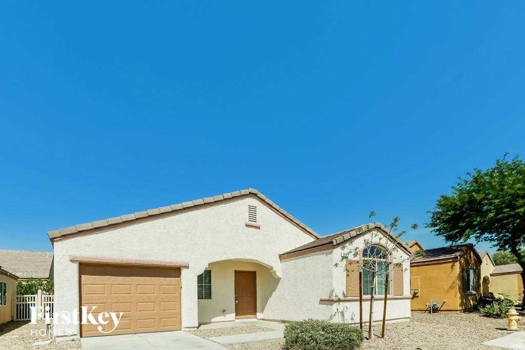 A house with a brown garage door is for sale.