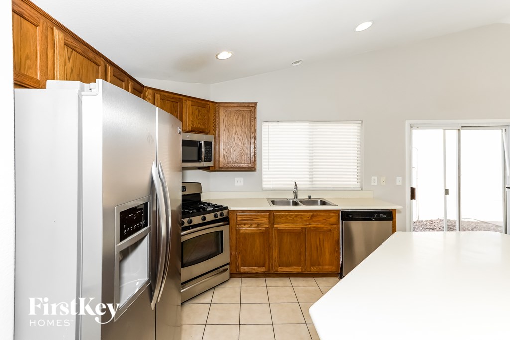 A kitchen with wooden cabinets and a white refrigerator.