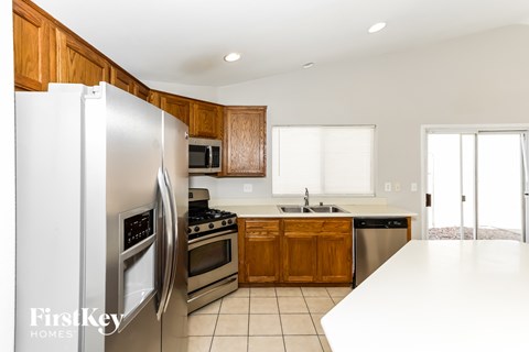 A kitchen with wooden cabinets and a white refrigerator.