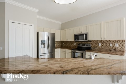 a kitchen with stainless steel appliances and a wooden counter top