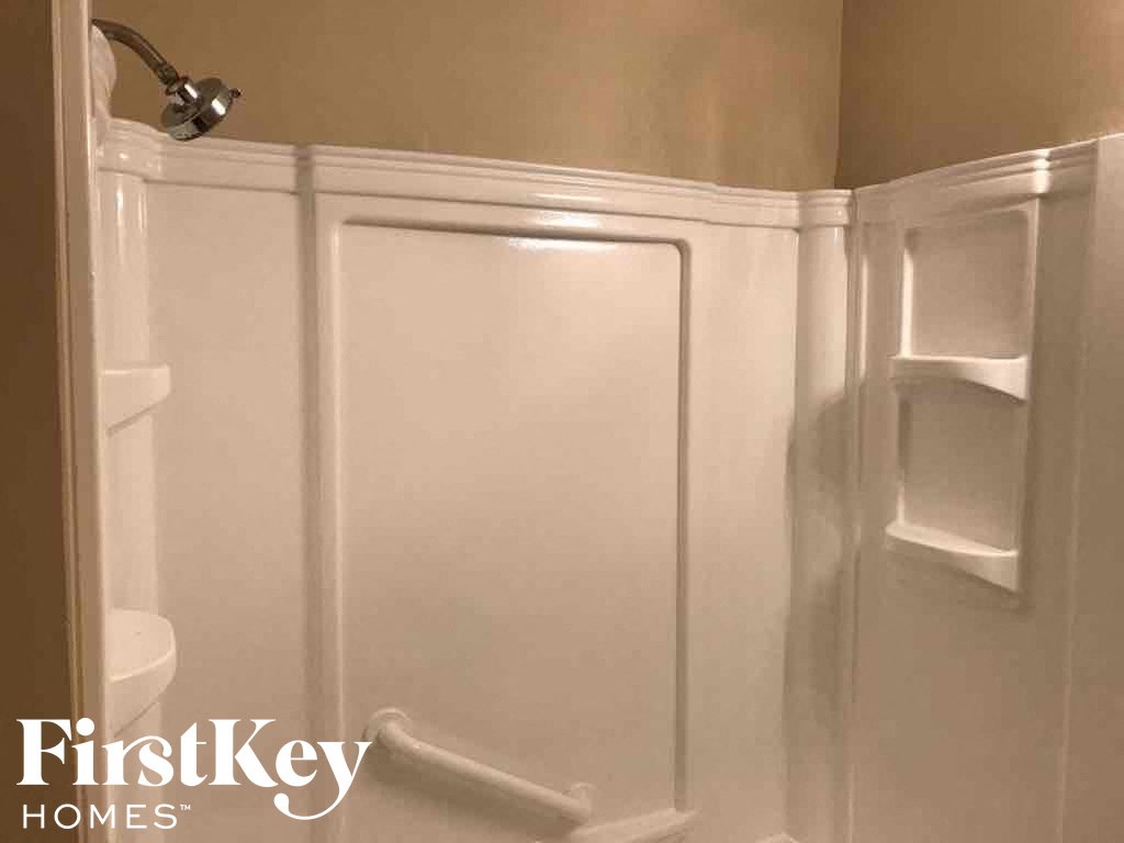 A white bathroom with a FirstKey Homes logo.