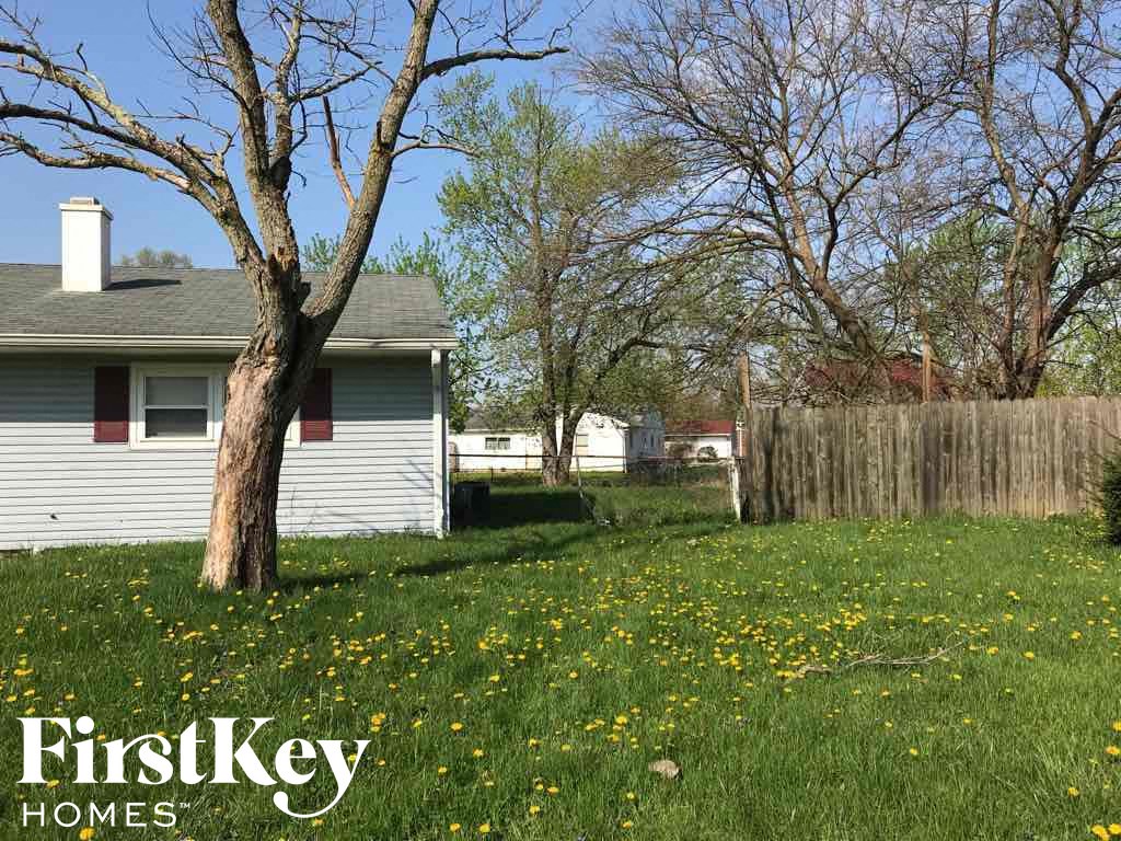 A house with a tree in front of it and the words "FirstKey Homes" on the bottom.