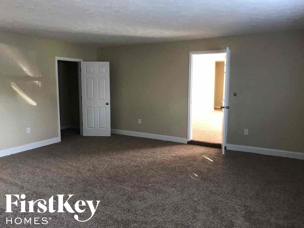 A room with two doors and a carpeted floor.