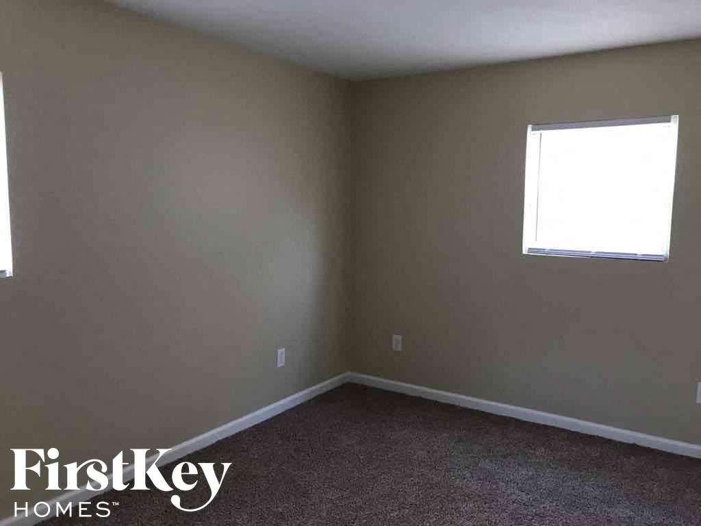 A room with a FirstKey Homes logo on the bottom left corner.