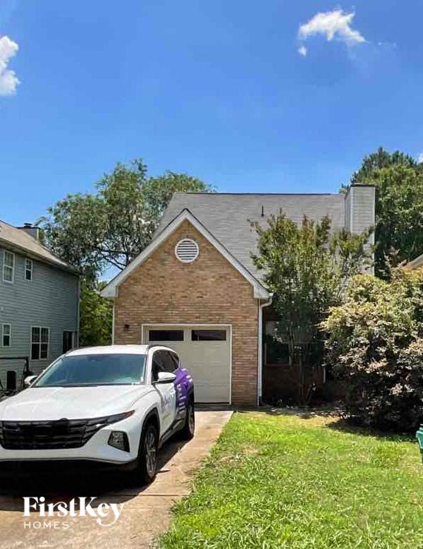 a car parked in a driveway in front of a house