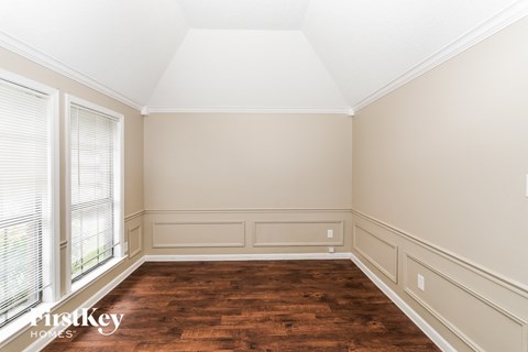 A room with wooden floors and white walls.