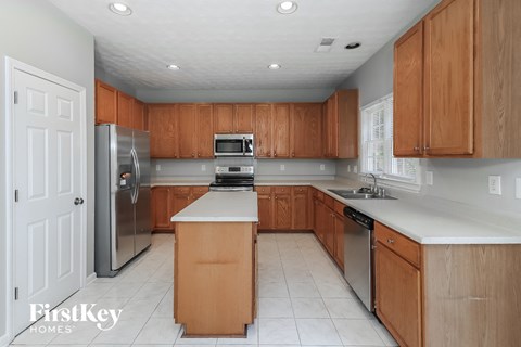 a kitchen with wooden cabinets and stainless steel appliances