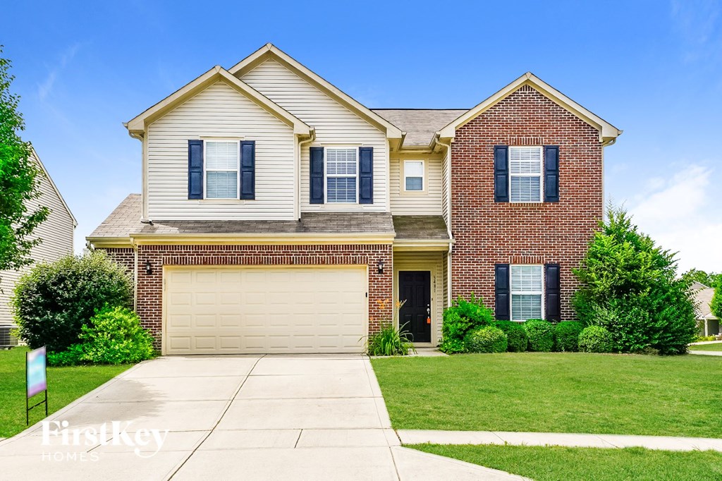 a large brick house with a white garage door