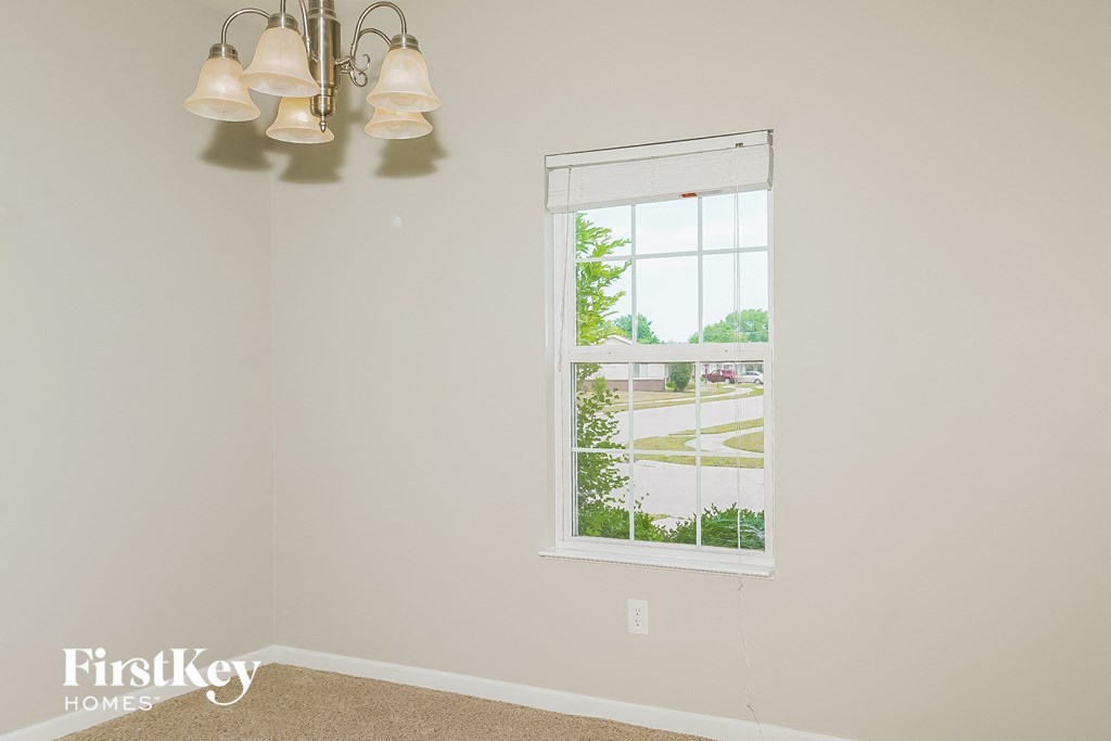 a view of a window in a white room with two lamps