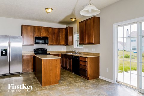 a kitchen with wooden cabinets and stainless steel appliances