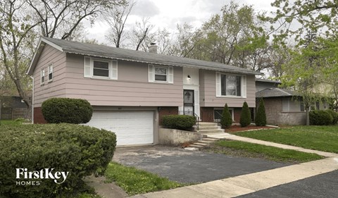 a beige house with a white garage door