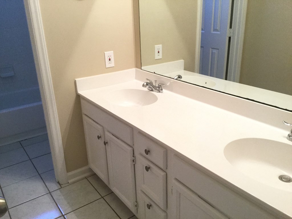 a bathroom with two sinks and a large mirror