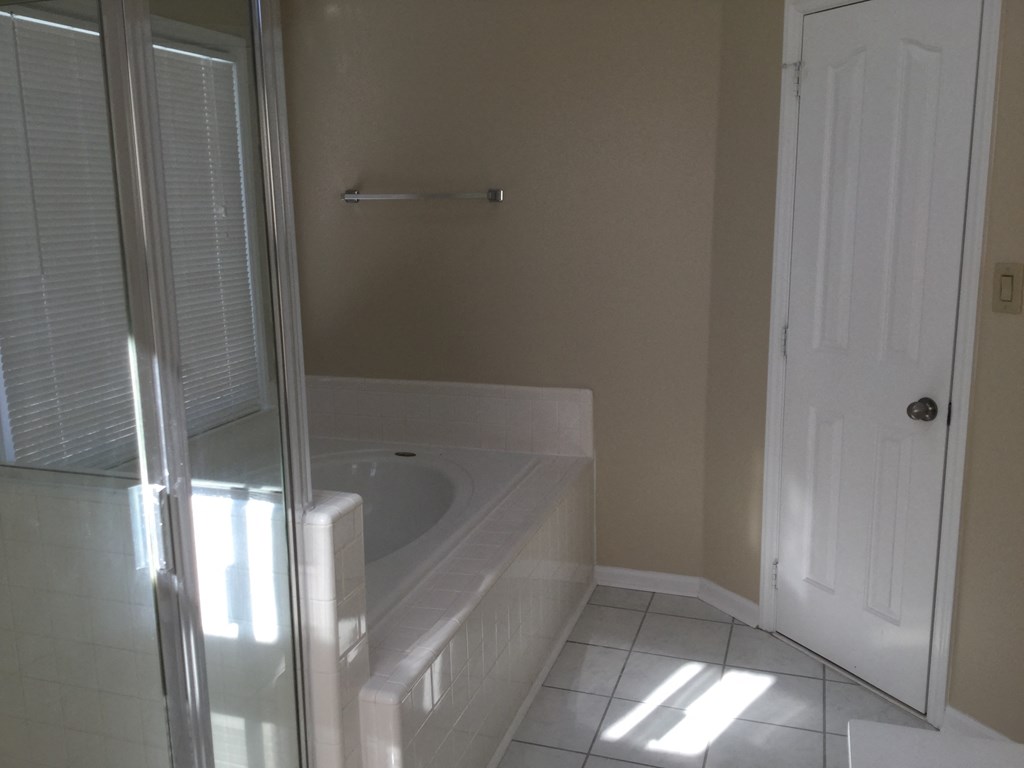 a bathroom with a jacuzzi tub and a shower