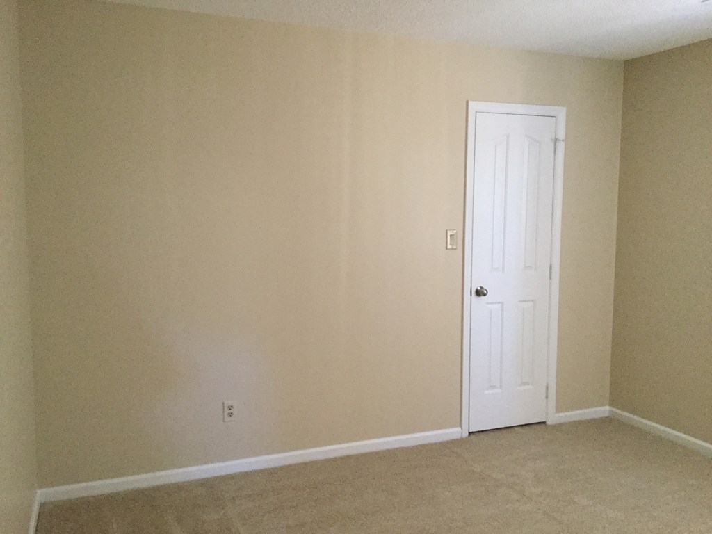 an empty room with a white door