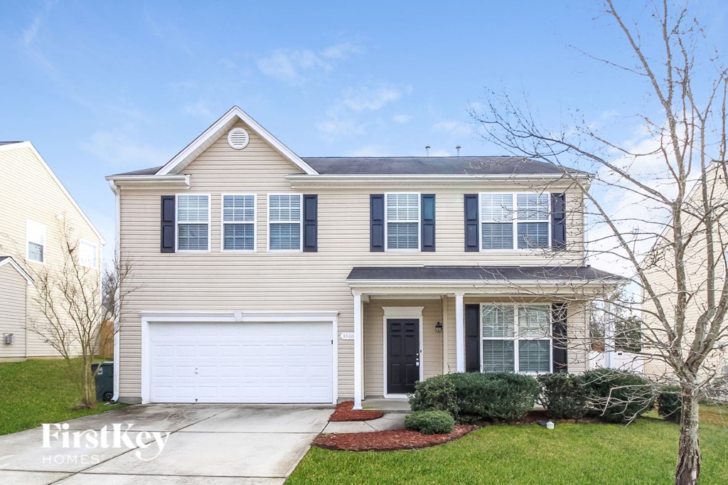 A two-story house with a garage and a front door.